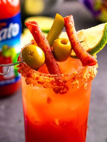 Takis Caesar in a glass.