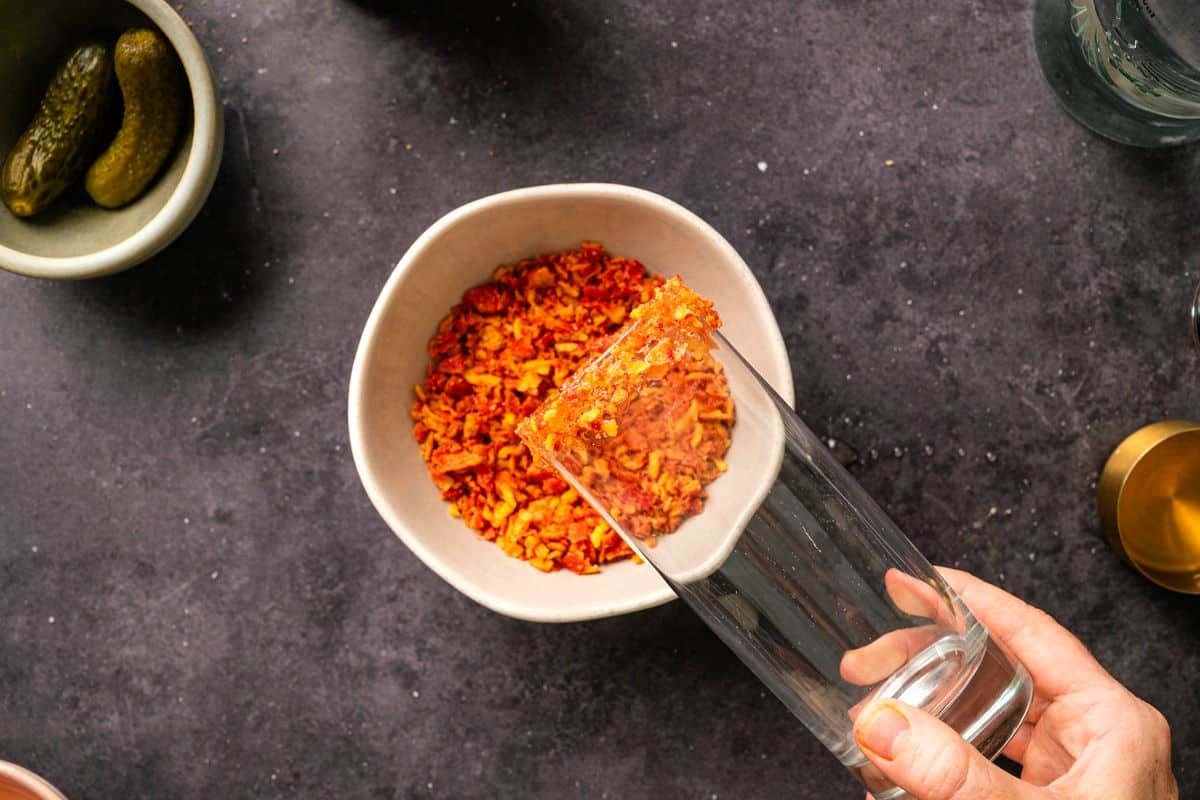 Collins glass dipped into crushed takis chips.
