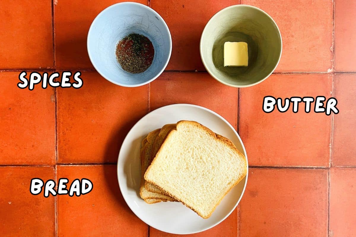 Toast point ingredients labeled on orange tile background.