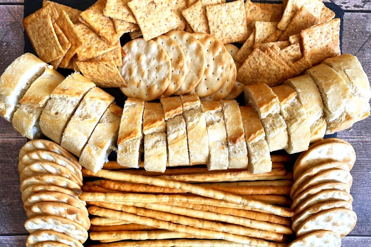Tray of assorted crackers and baguette slices.