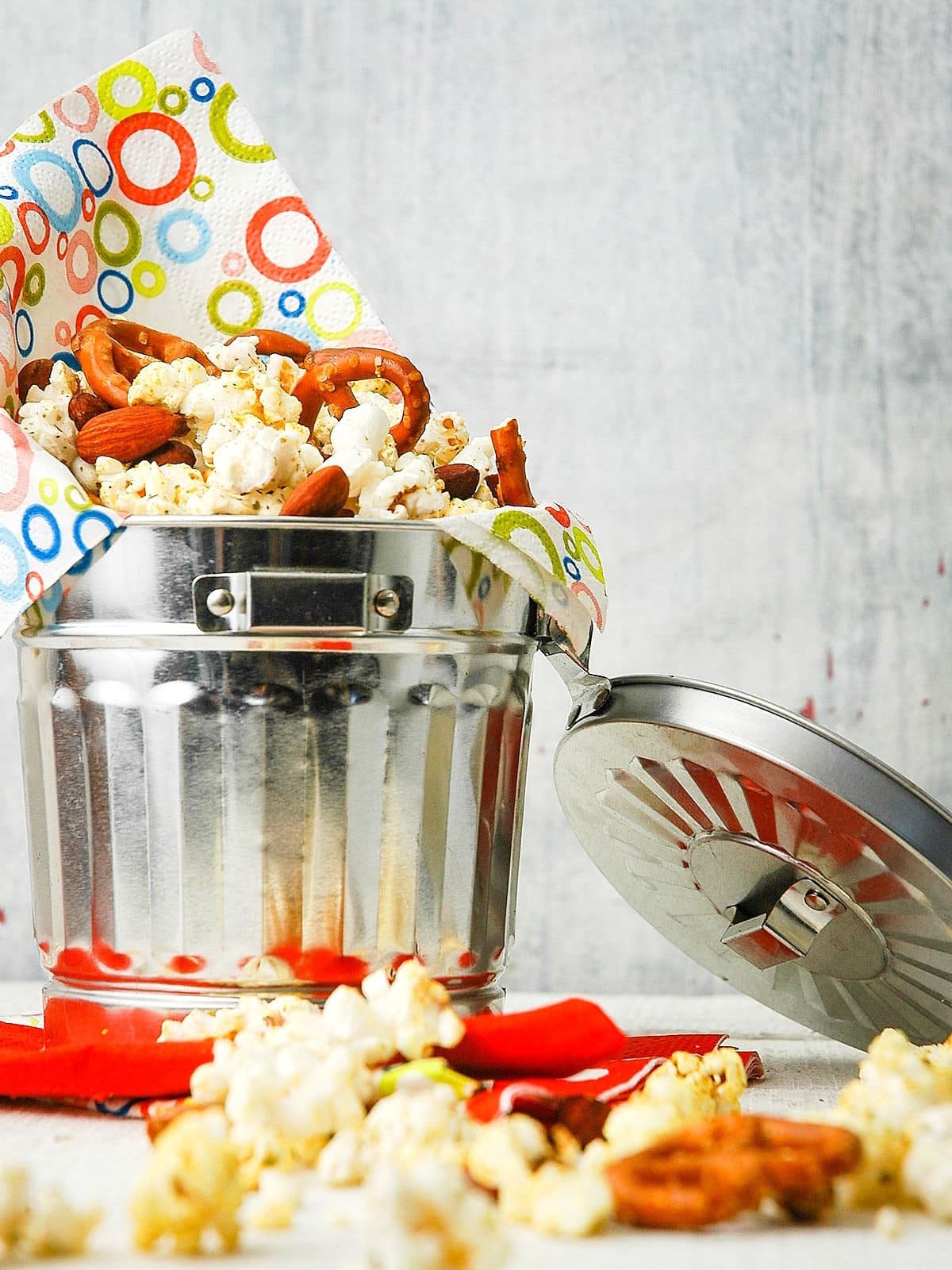 Popcorn snack mix in metal bucket.