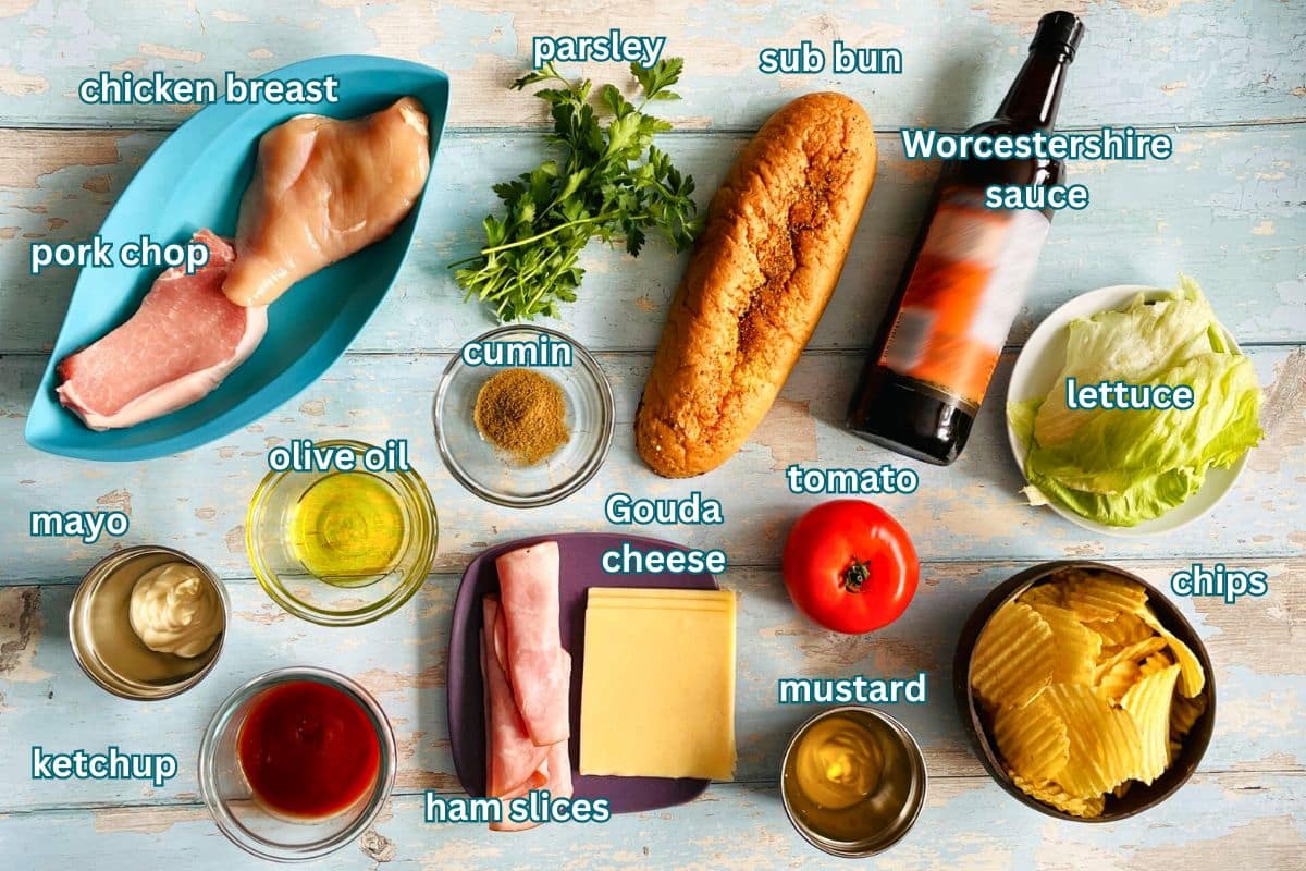 Tripleta sandwich ingredients labeled on blue wooden background.