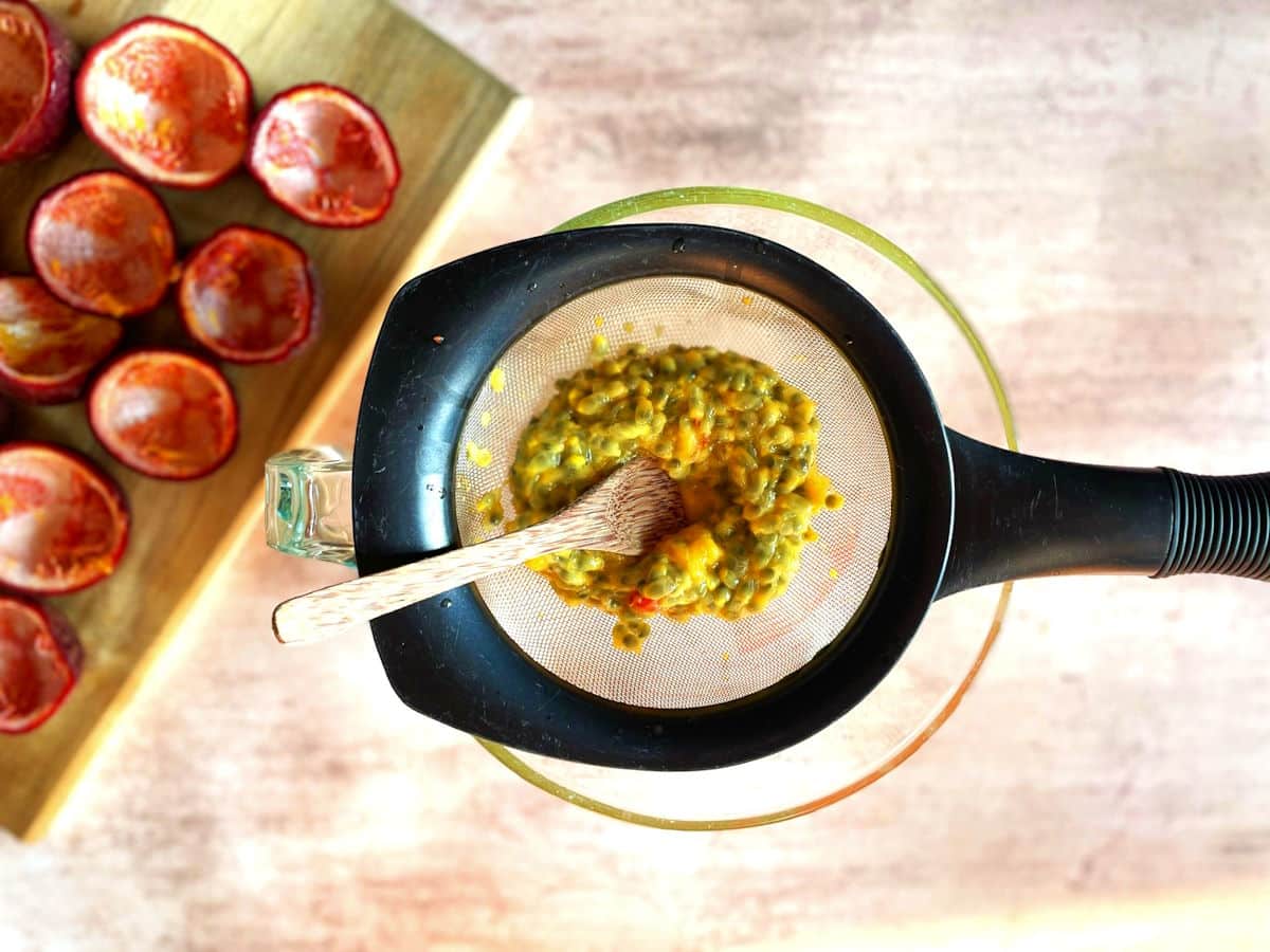 Passion fruit pulp in strainer.
