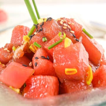 Tuna watermelon tartare on clear glass plate.