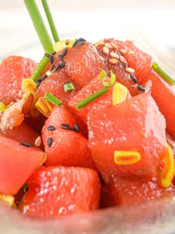 Tuna watermelon tartare on clear glass plate.