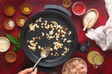 Toasted almonds in electric skillet.