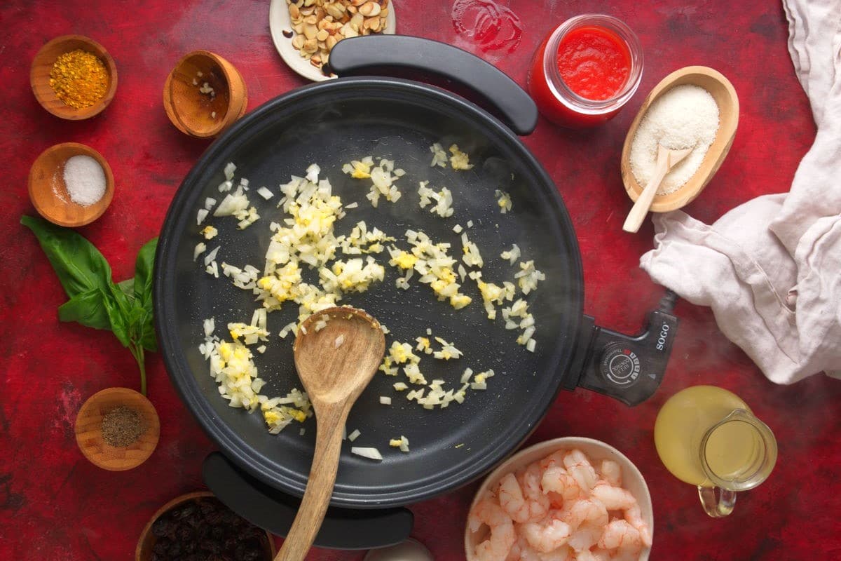 Cooked onions, ginger and garlic in electric skillet.