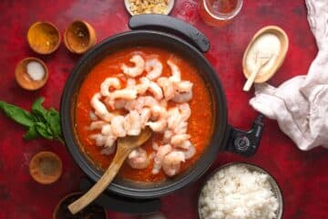 Curry and raw shrimp in electric skillet with lid.