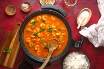 Shrimp curry with fresh basil in electric skillet.