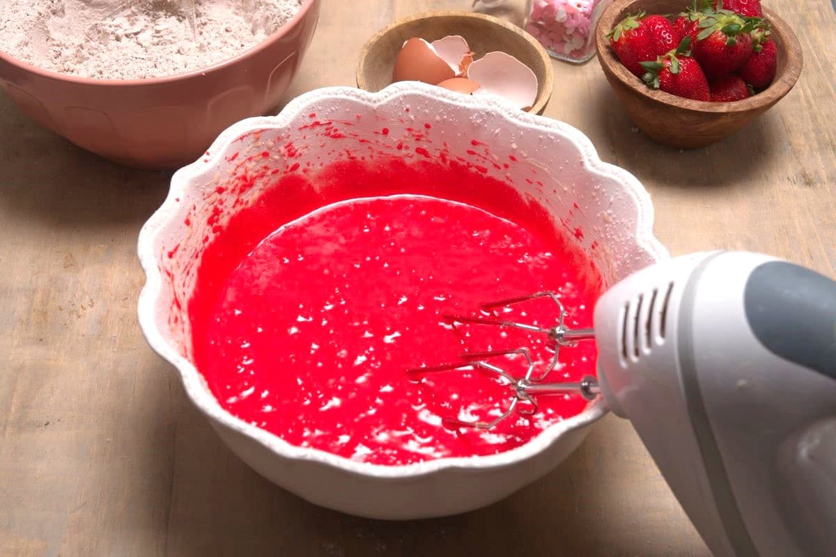 Red cake batter in bowl.