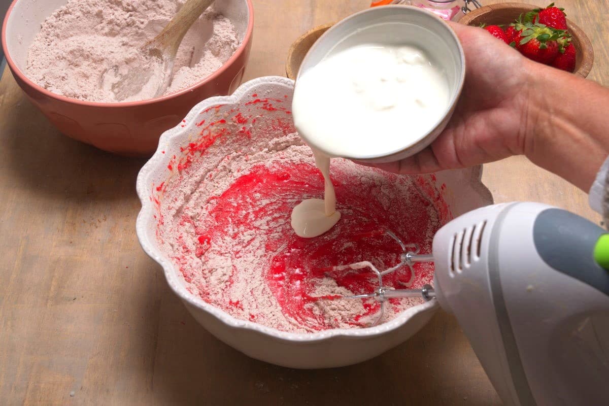 Red velvet cake ingredients in bowl.