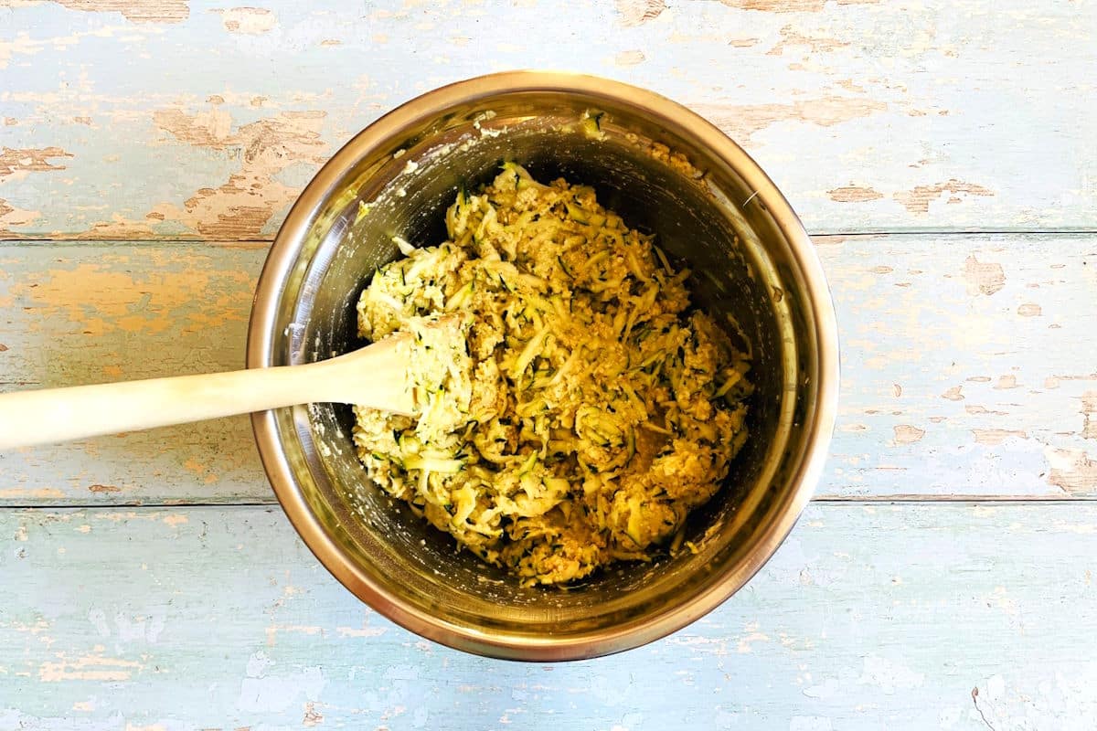 Uncooked zucchini crab cake mixture in bowl.