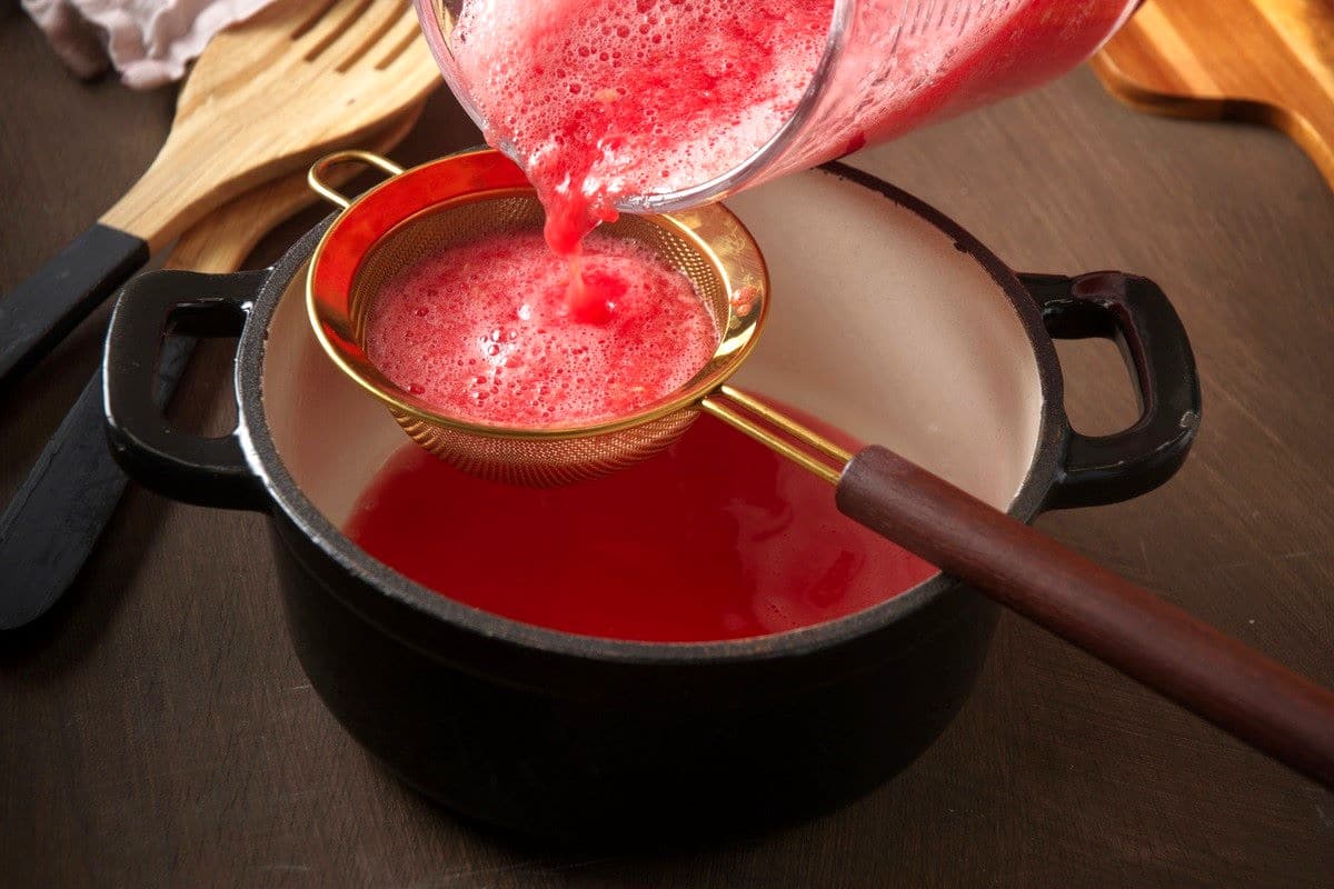 Watermelon purée in strainer.