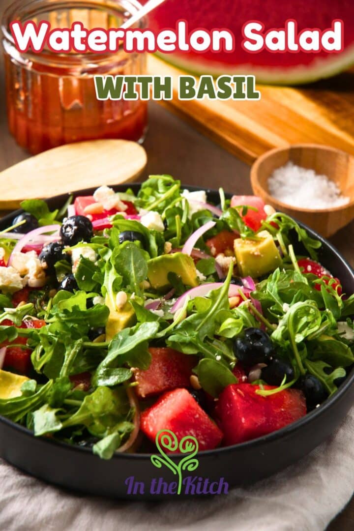 Watermelon salad in black bowl with text overlay that says 'watermelon salad with basil'.