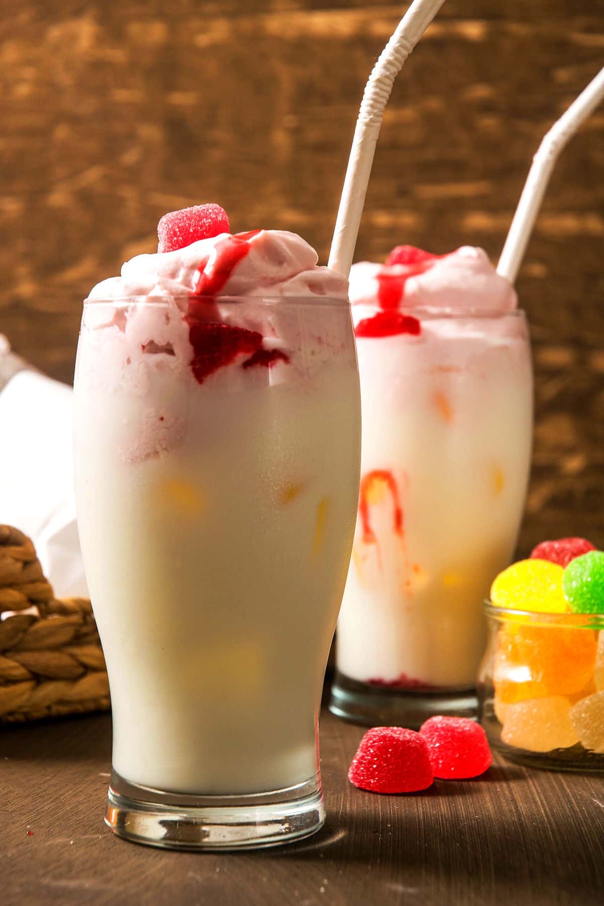 Strawberry whipped cream over milk in glasses.